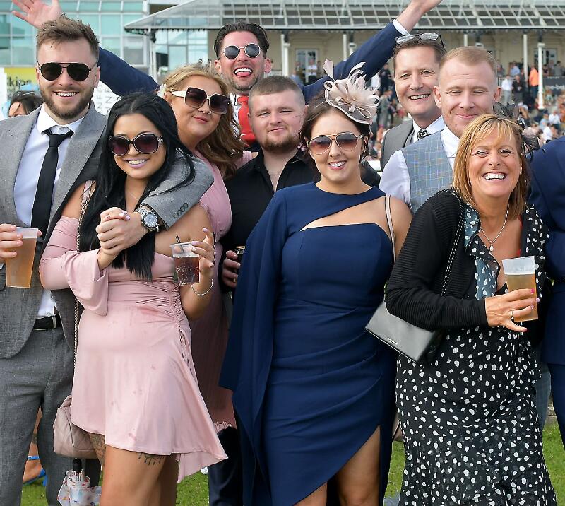 A large group enjoying the races
