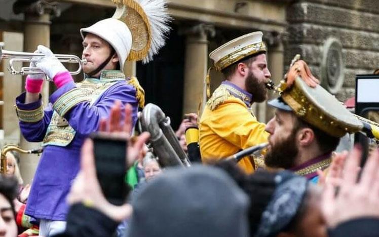 Band playing in front of crowds at Bath Racecourse.