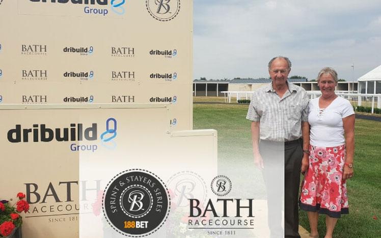 Glen and Fiona Symes posing for a photo at the track at Bath Racecourse.
