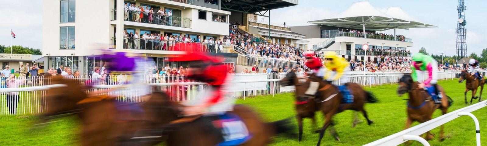 Crowds at Bath Racecourse enjoy an exciting day at the races.