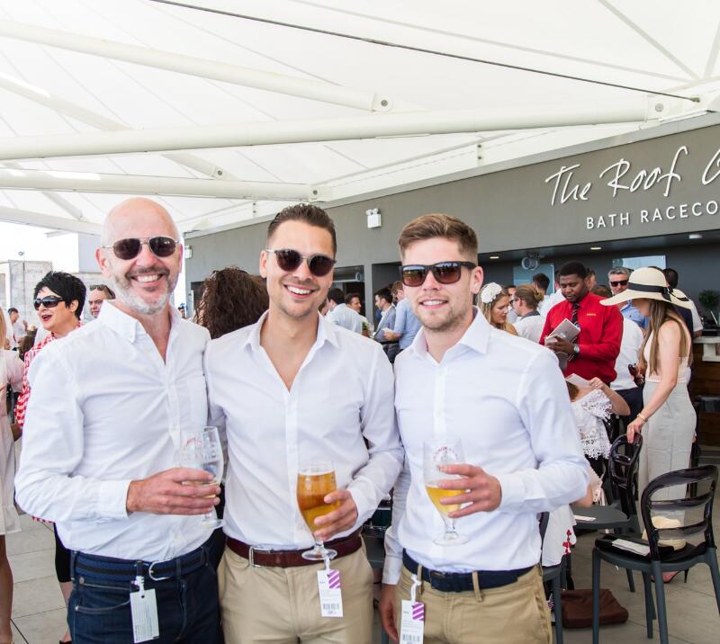 A group of guys enjoying the roof garden at Bath Races