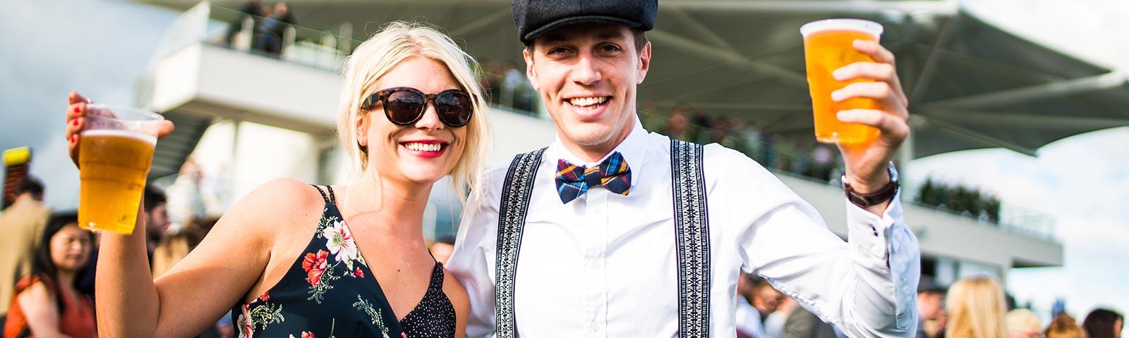A couple pose for the camera whilst holding a pint each.