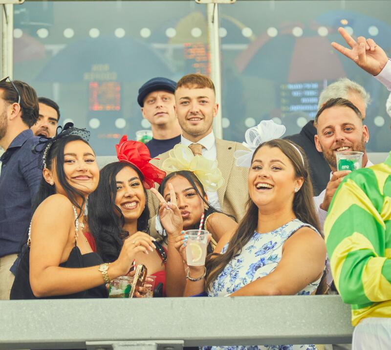 A group of young race goers in the stands at Bath